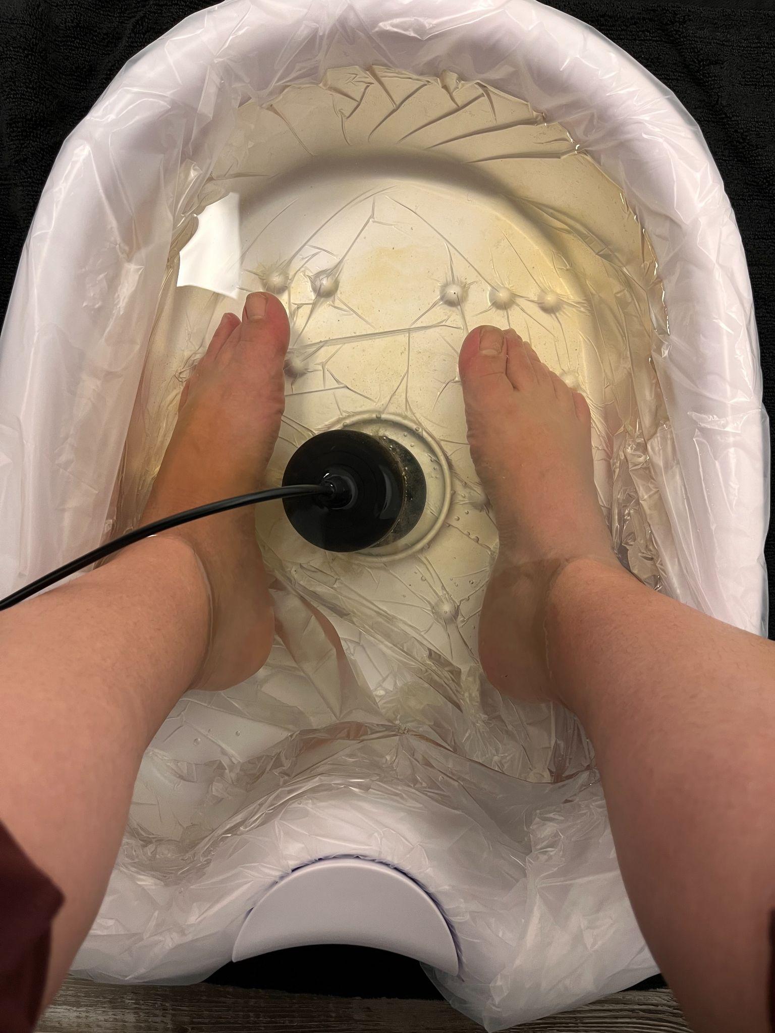 Ionic foot detox session at the start: clean water in basin