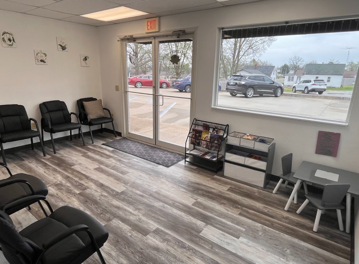 The Elite Spinal Chiropractic waiting room with seating and a children's table